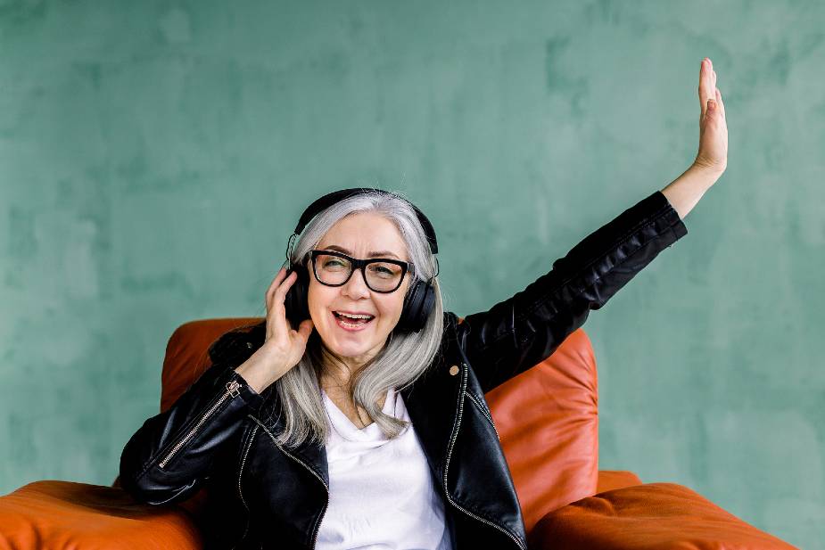 Mujer con pelo cano y largo escuchando música