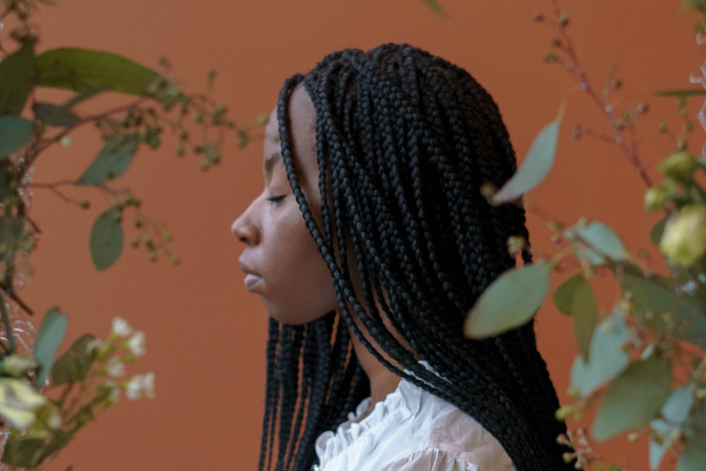 Femme abordant des tresses africain avec des mèches