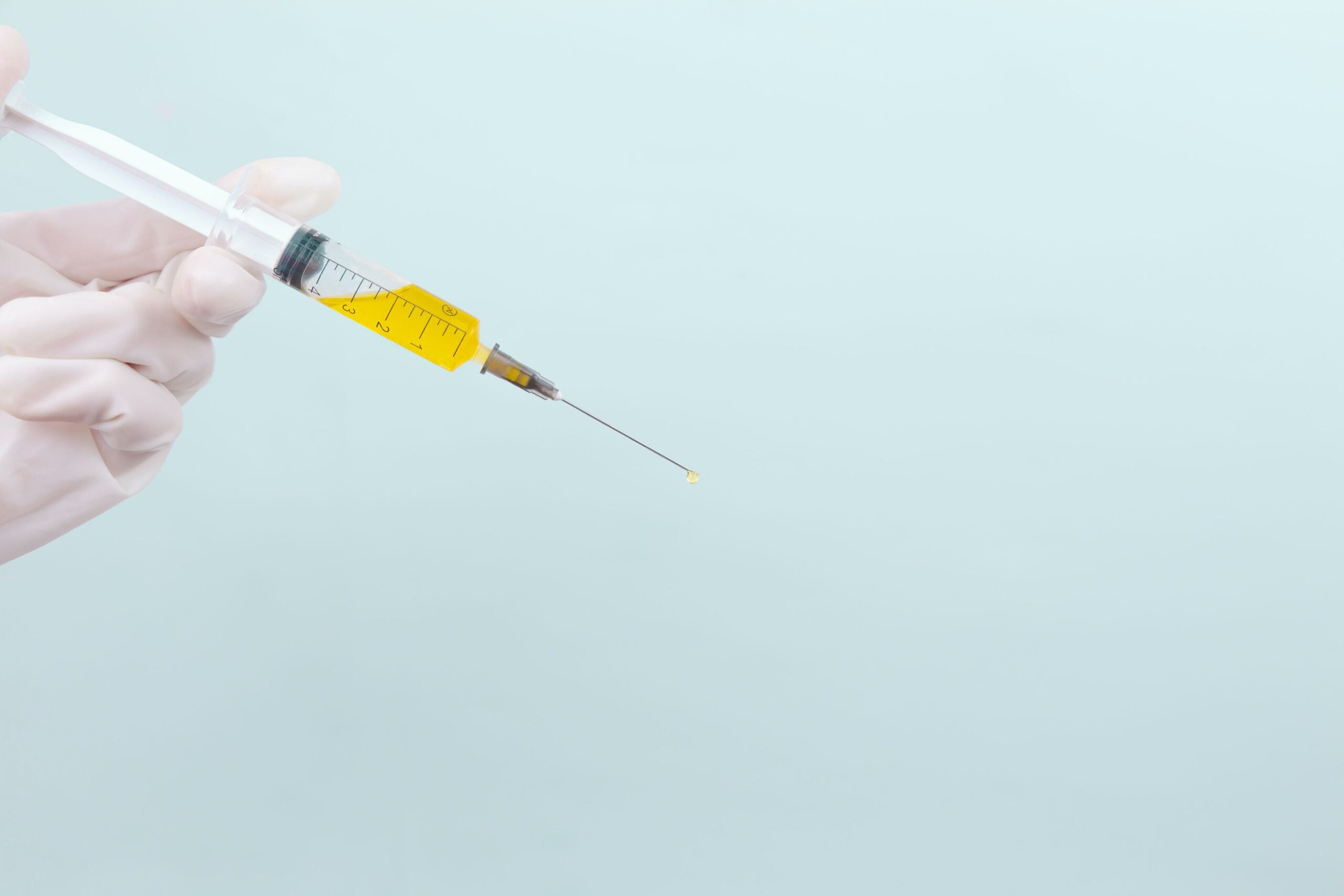 Doctor holding syringe with micrografting serum