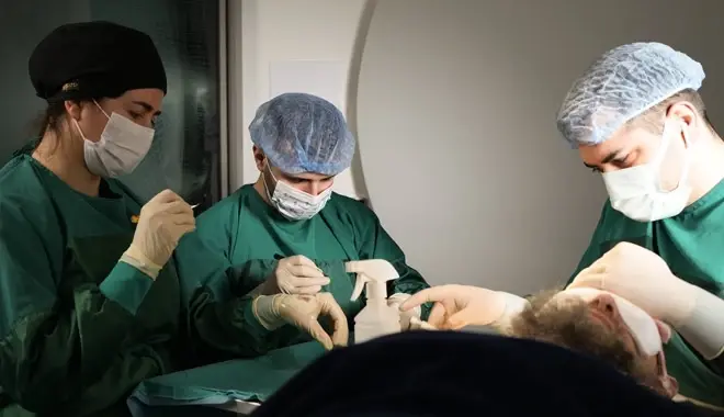Elithair specialists performing hair transplant with patient