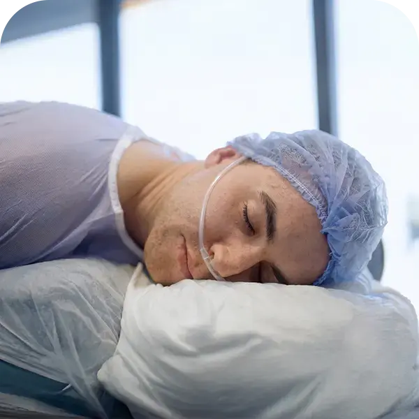 Hair transplant procedure with painless anesthesia showing patient comfort during local numbing before treatment