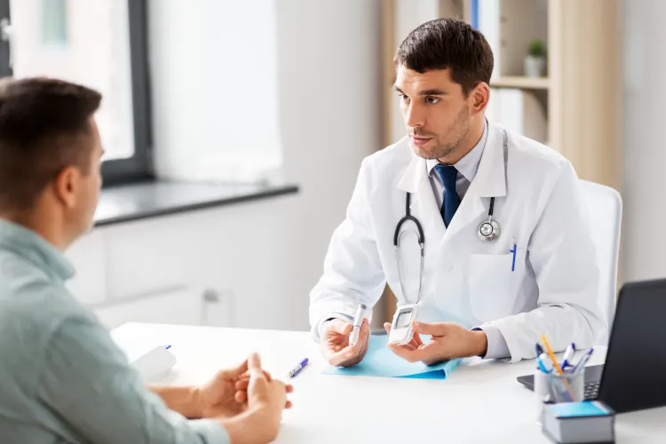 A doctor holding an insulin pen while advising a patient with diabetes