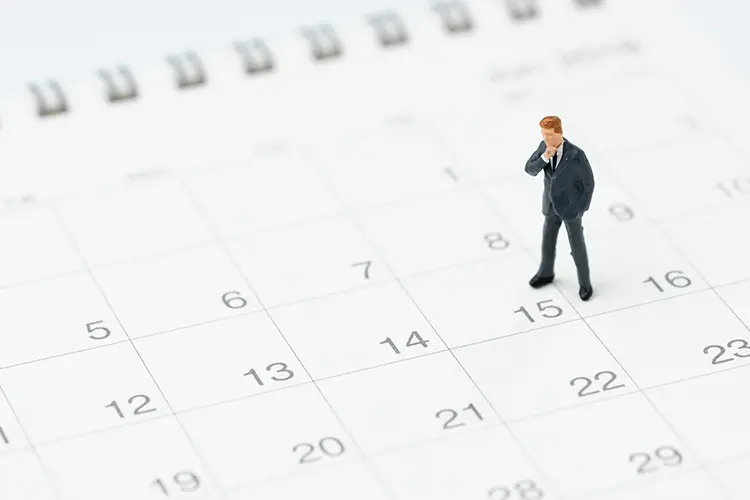 Illustration of a man standing on a calendar and looking at it thoughtfully