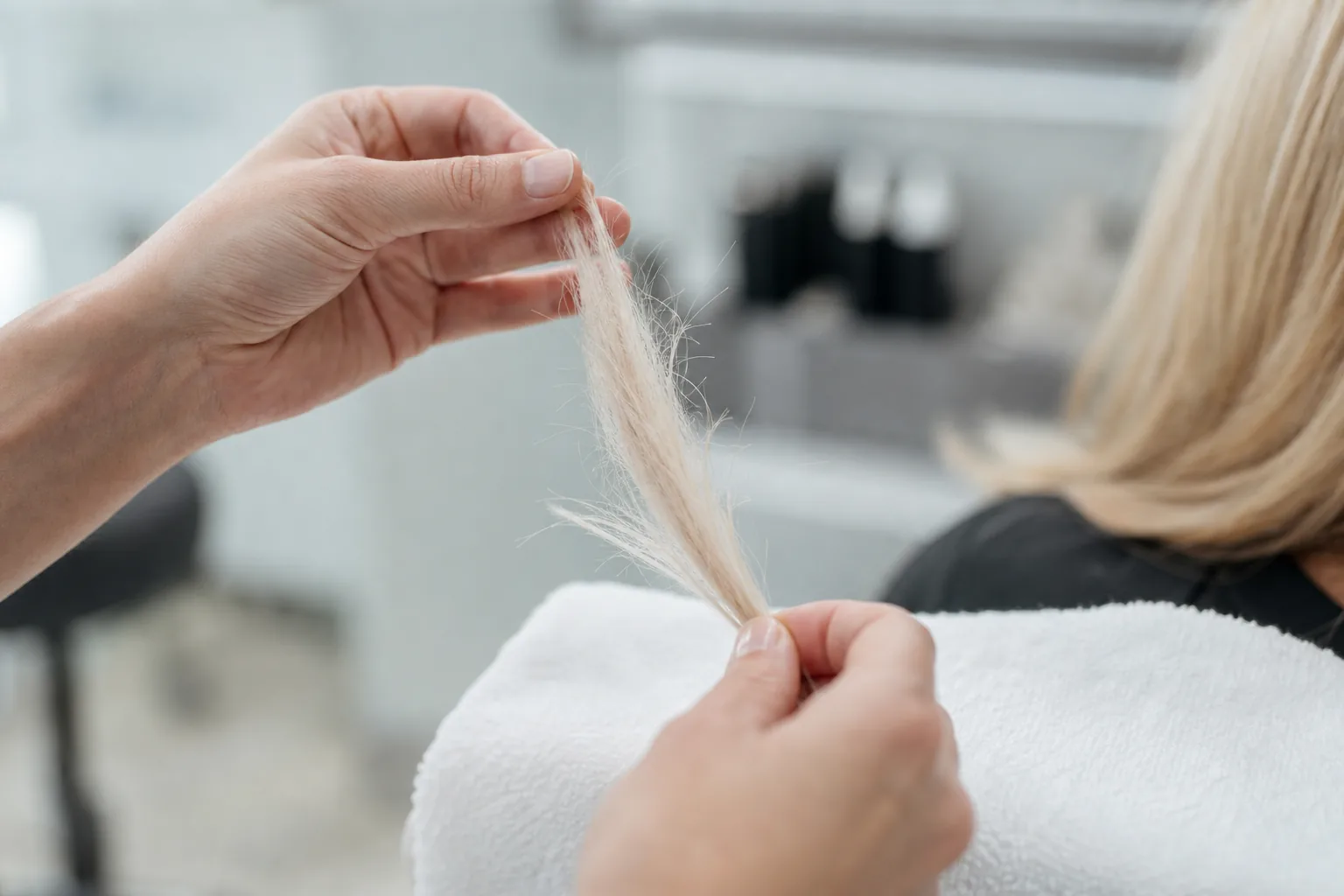 A bleached section of hair is checked for breakage and porosity