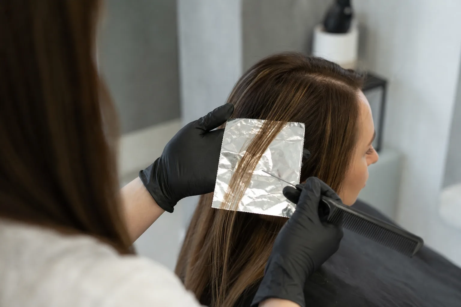 Foil highlights are applied at a distance from the hairline, leaving the scalp untouched