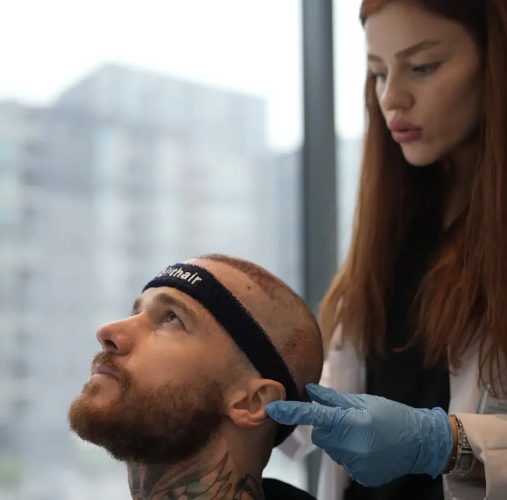 Elithair specialist checking a patient with headband after the hair transplant